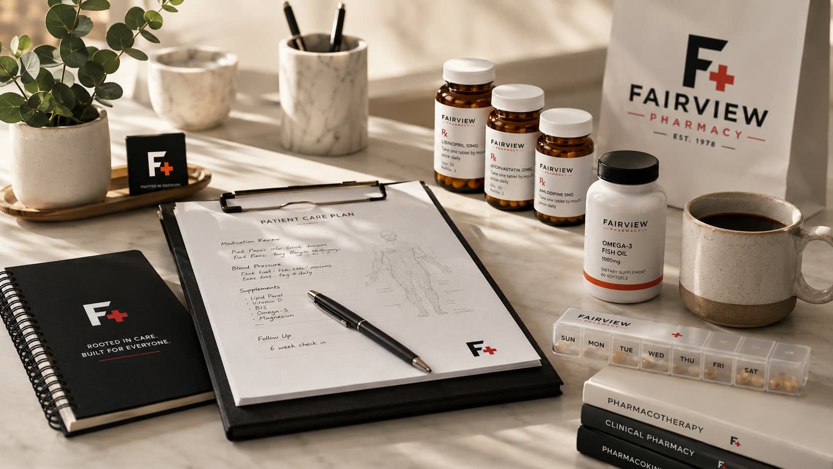 From the pharmacist's desk: Fairview Pharmacy patient care plan clipboard with branded Rx bottles, supplements, weekly pill organizer, and pharmacology textbooks on a marble counter